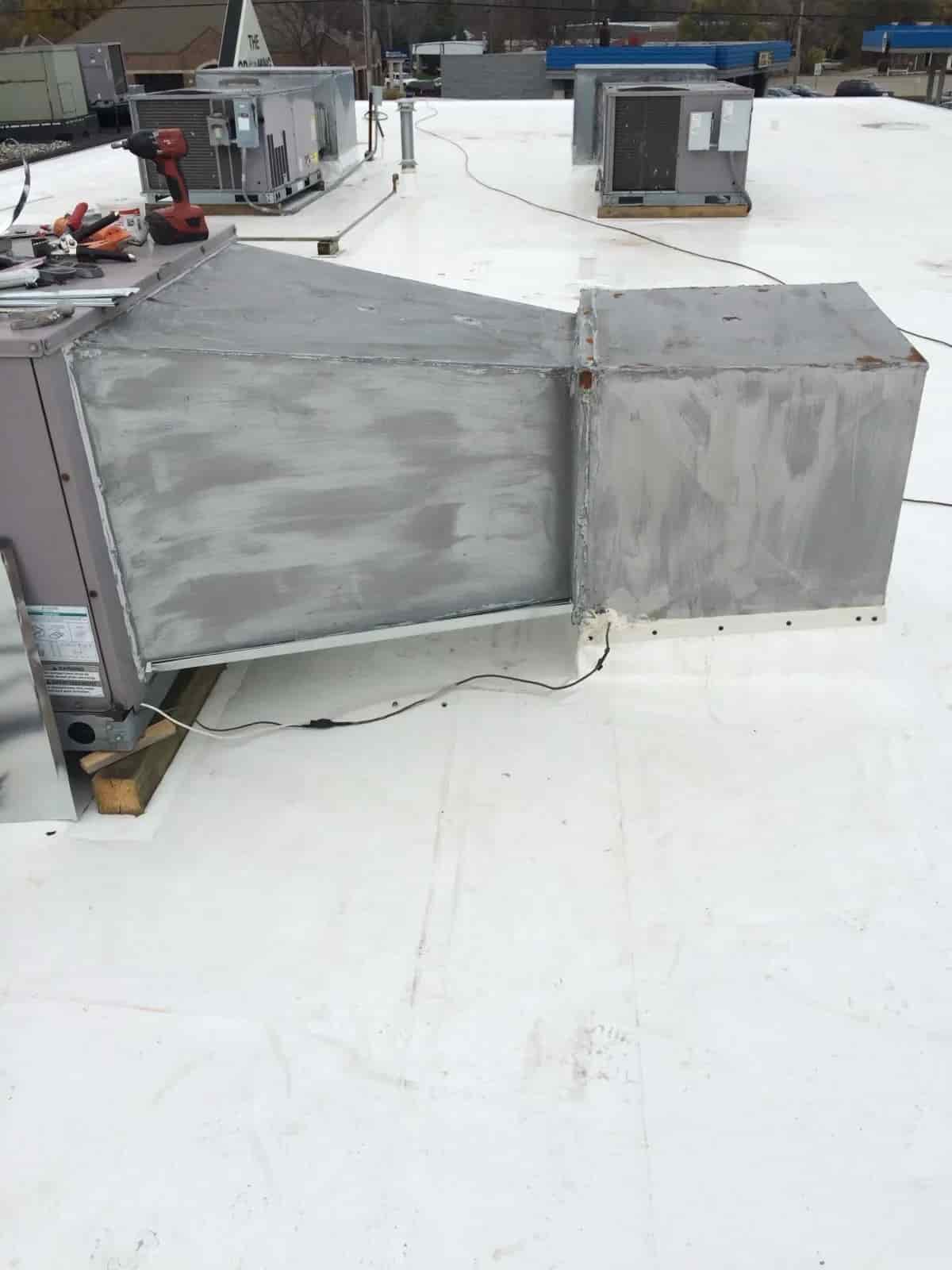 Mazure's technician repairing an air conditioning unit